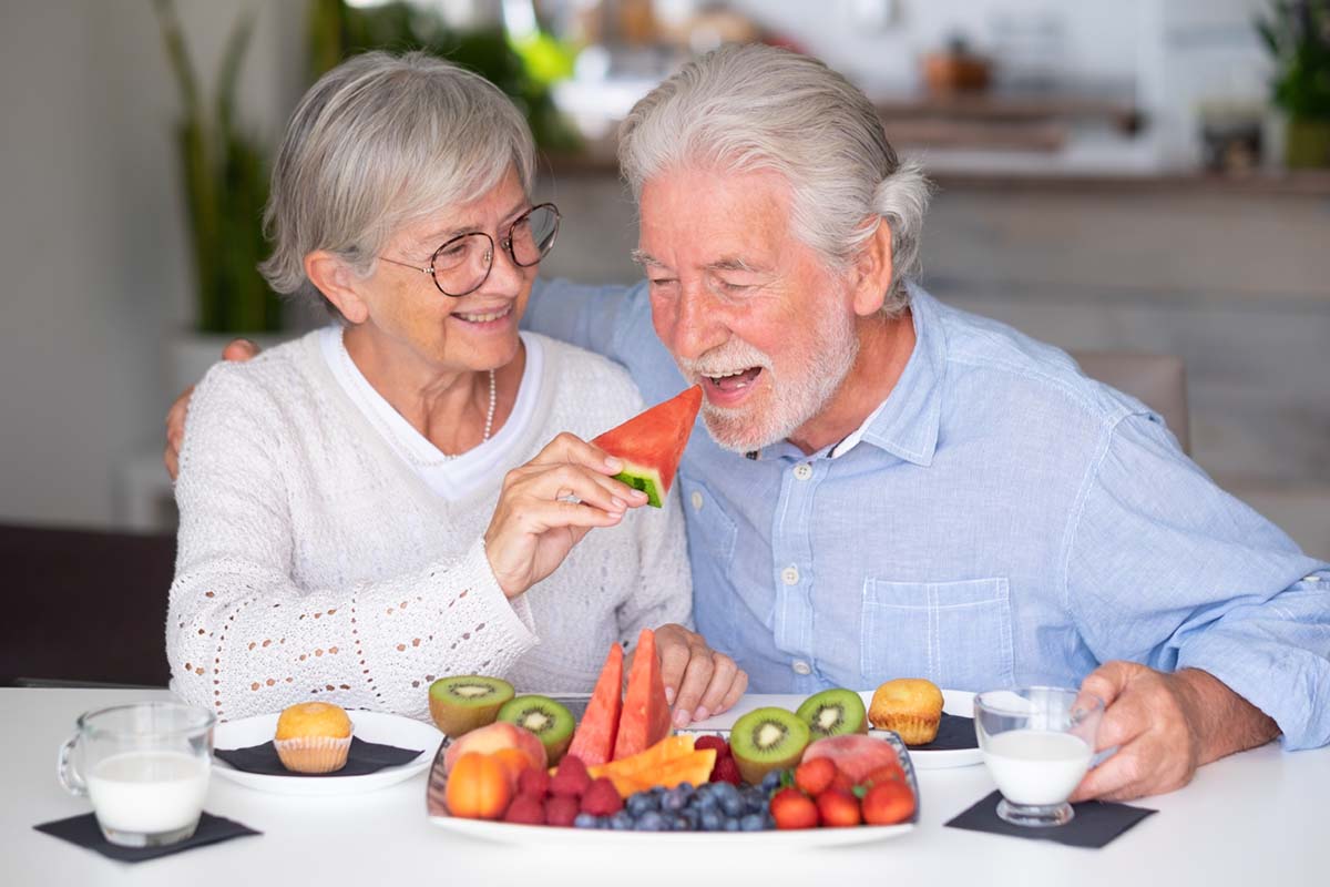 Beautiful caucasian retired senior couple having breakfast at ho