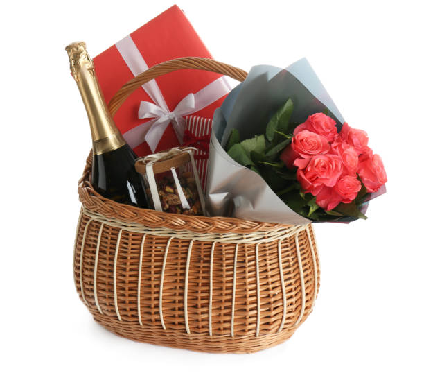 Wicker basket full of presents isolated on white