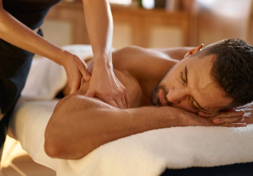 Relaxed man enjoying massage in spa